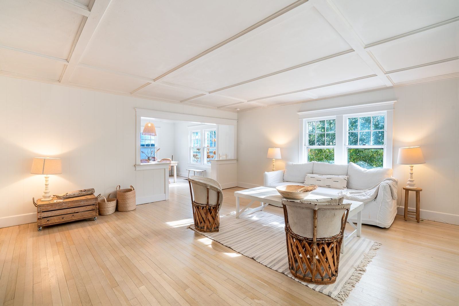 Front living room with three sides of windows and coffered ceiling